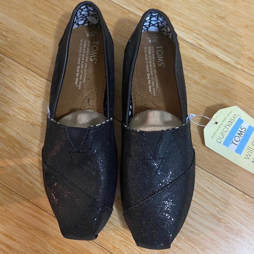 Tom’s original black sparkle shoes. NWT, size 6.